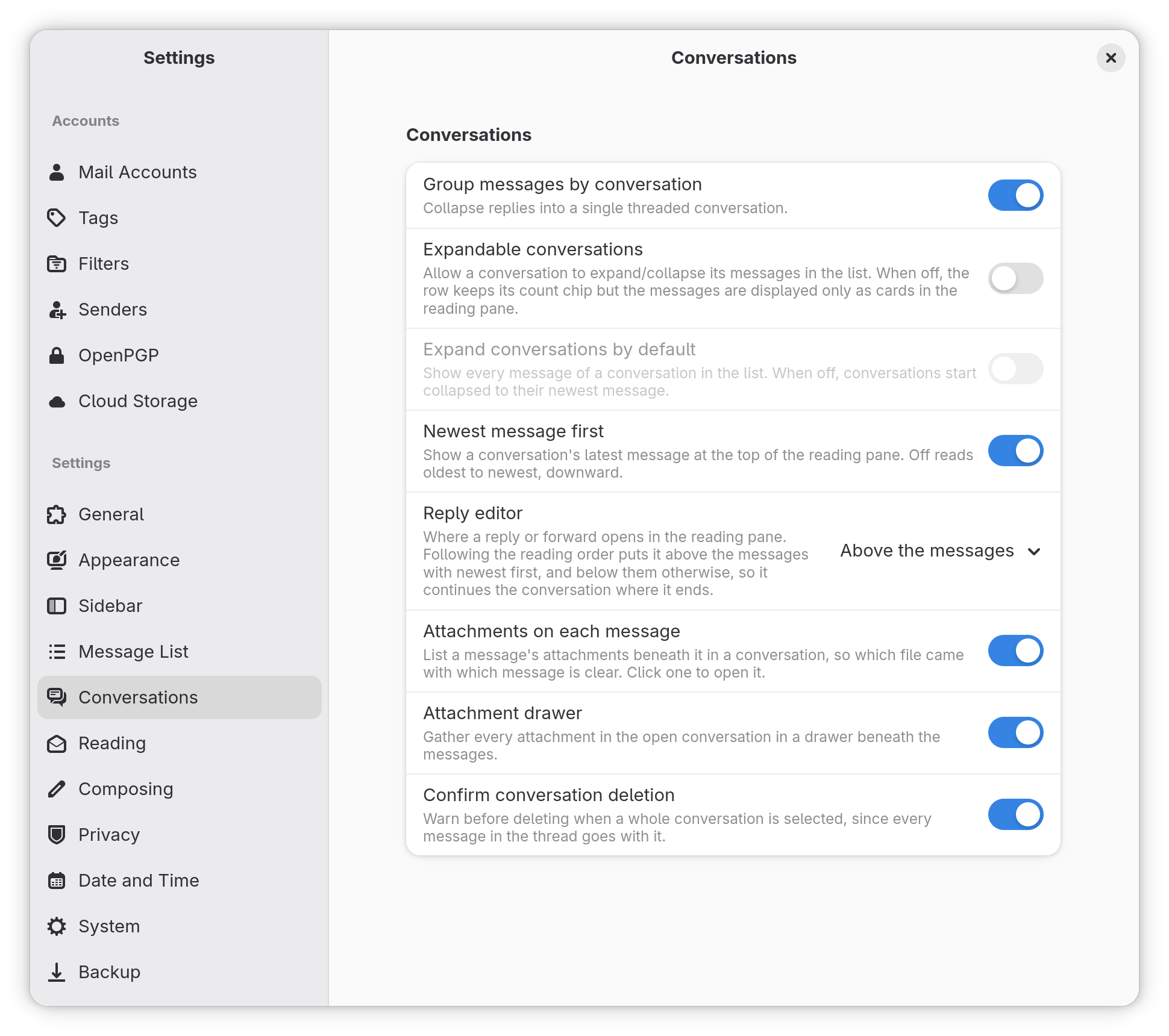 The Settings window on its Conversations page: switches for grouping messages by conversation, expanding them, newest message first, per-message attachments and the attachment drawer, with each option explained in a line beneath
